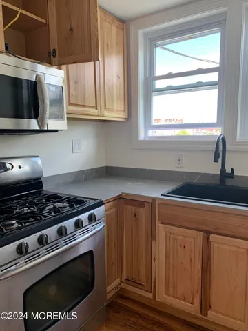 a kitchen with wooden cabinets and a stove top oven