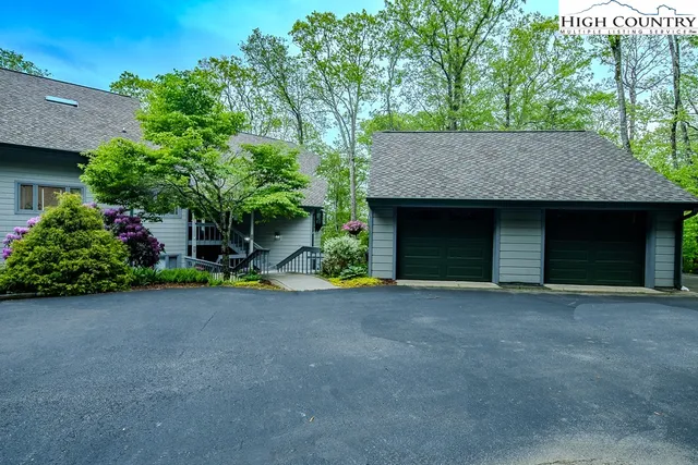 a view of a house with a yard and garage