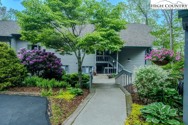 a front view of a house with a yard and fountain