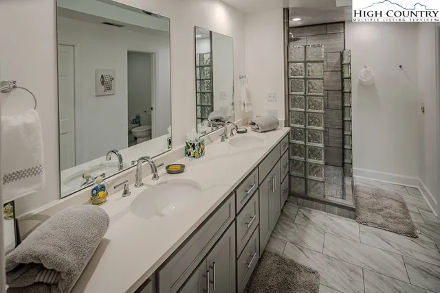 a bathroom with a tub sink and mirror