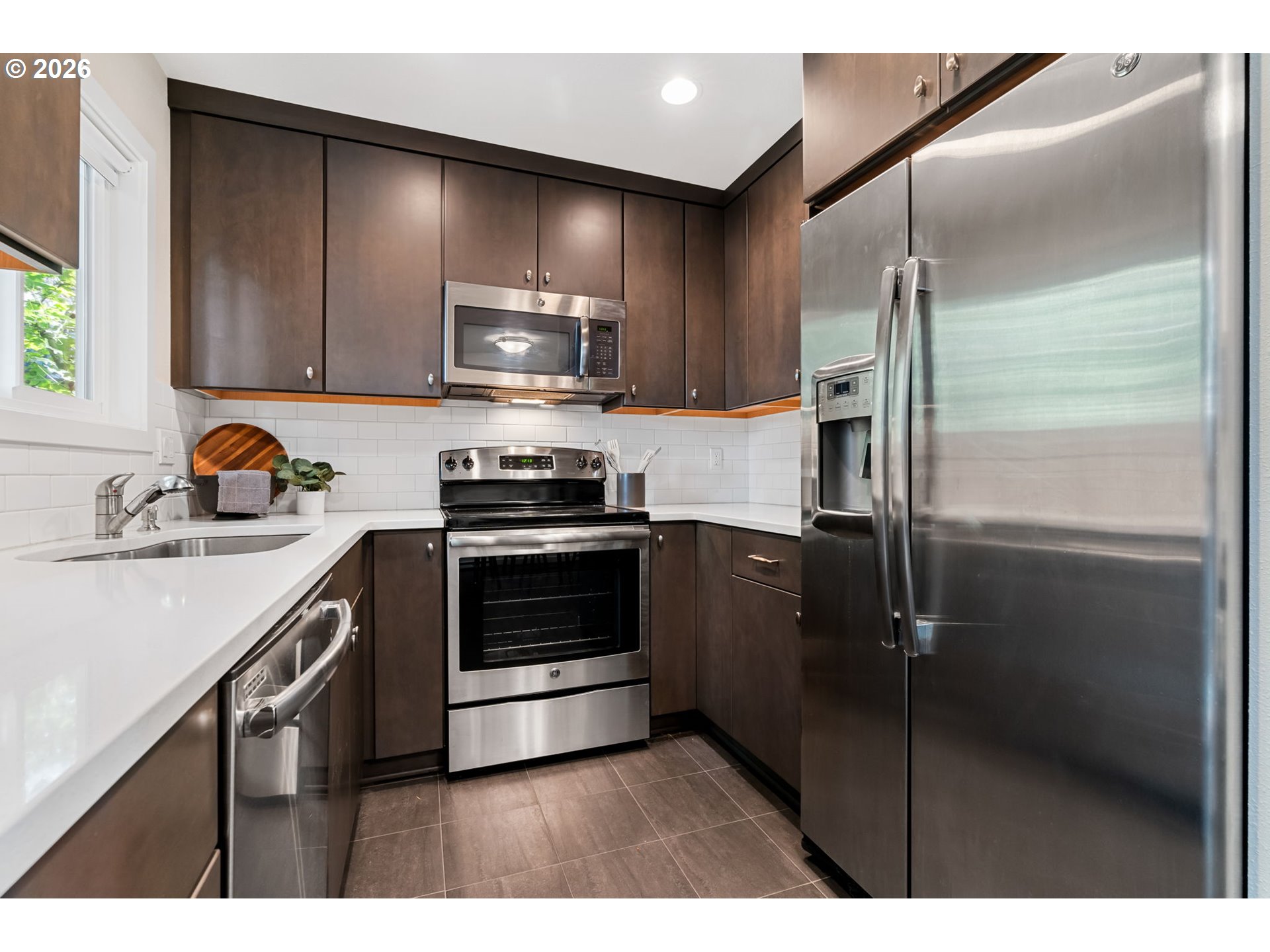 1442 Southwest 66th Avenue Portland, OR 97225 - Photo 11 of 31 a kitchen with a refrigerator and a sink