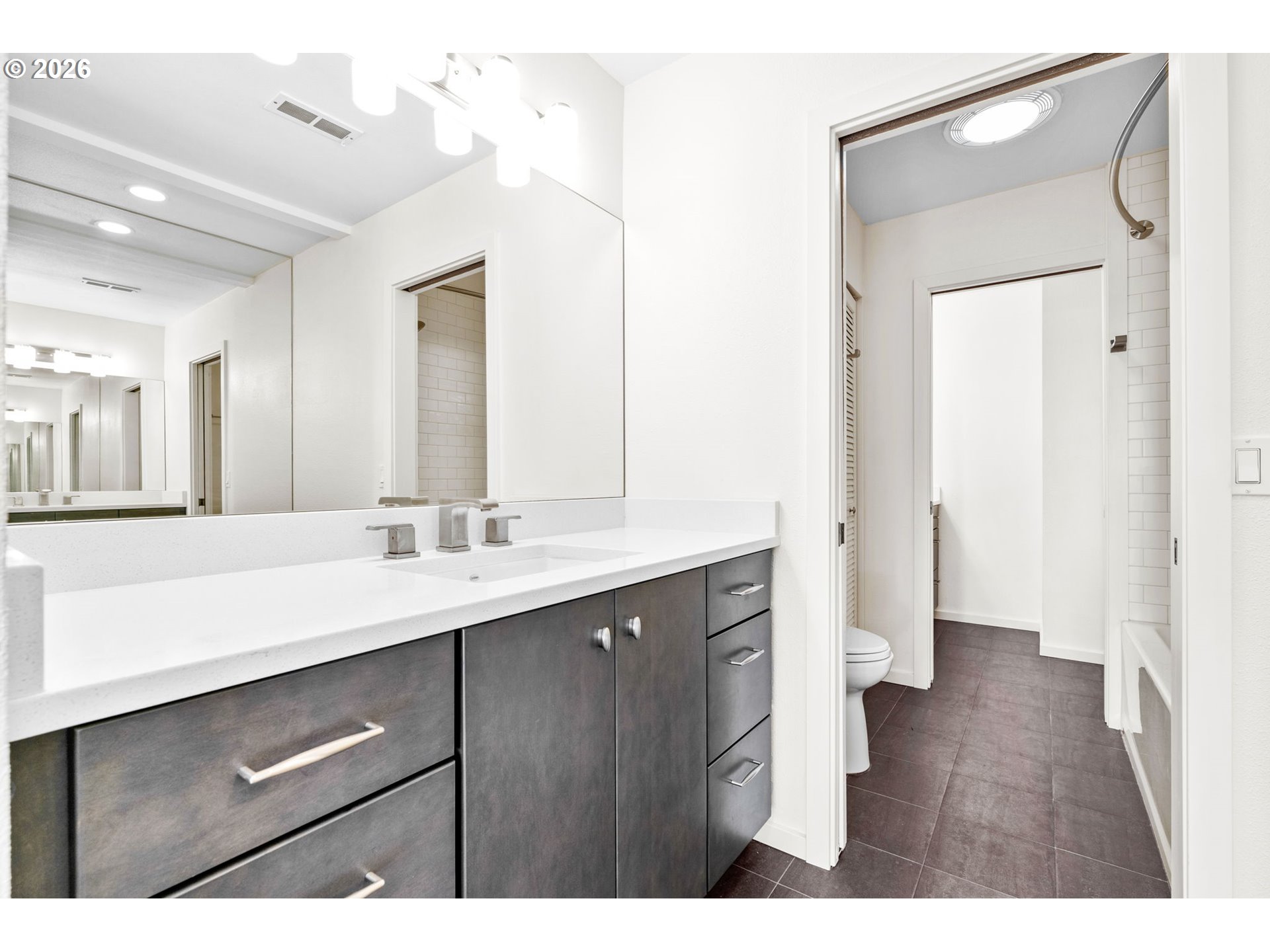 1442 Southwest 66th Avenue Portland, OR 97225 - Photo 26 of 31 a bathroom with a sink a toilet a shower and a mirror
