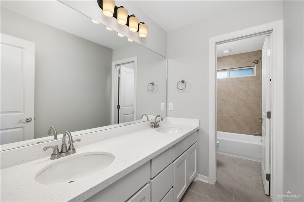 14616 Aqualina Way McAllen, TX 78504 - Photo 14 of 26 a bathroom with a sink a shower and a mirror