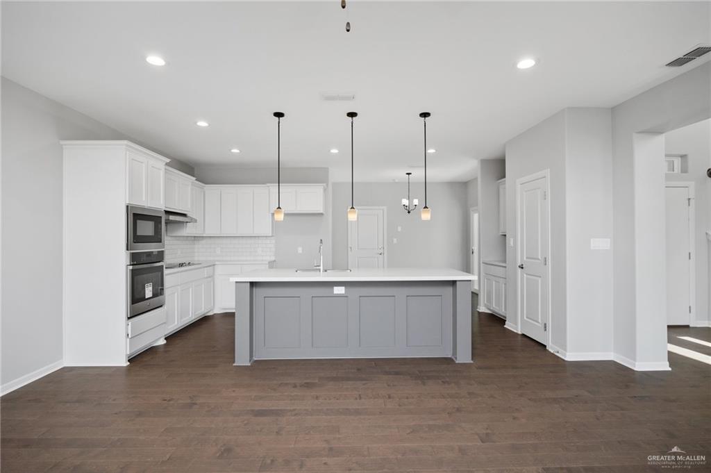 14616 Aqualina Way McAllen, TX 78504 - Photo 5 of 26 a large kitchen with cabinets and a refrigerator