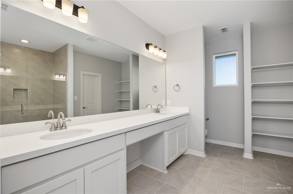 14616 Aqualina Way McAllen, TX 78504 - Photo 8 of 26 a bathroom with a sink double vanity and a mirror