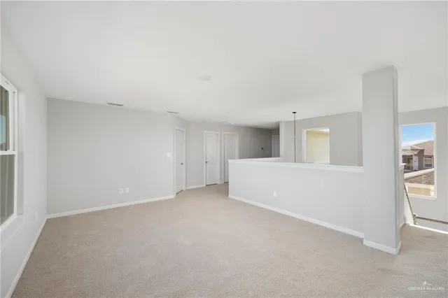 a view of an empty room with closet