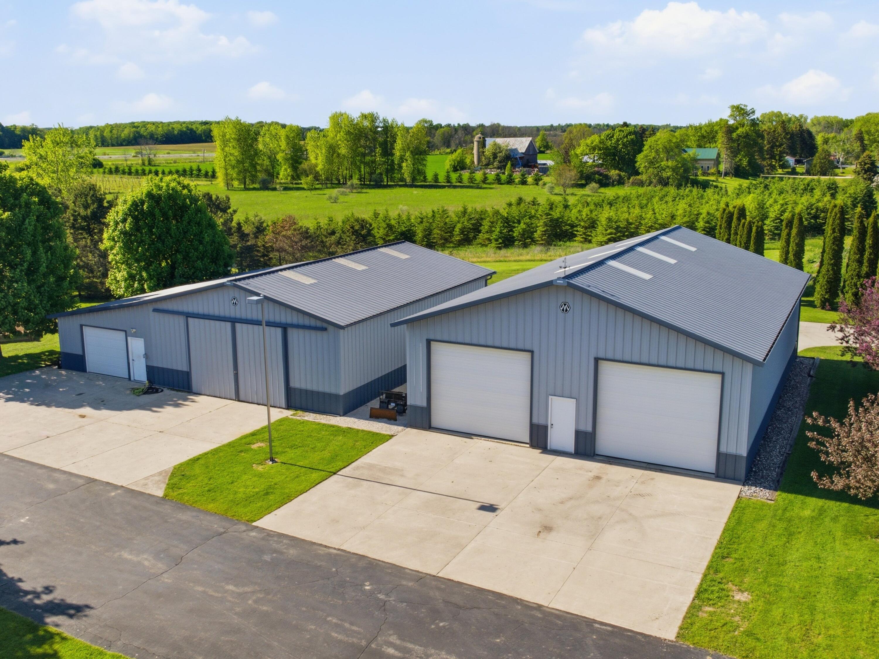 8520 South Gass Lake Road Newton, WI 53063 - Photo 4 of 38 Right: 60’ x 42’ pole building with concrete floor and three powered overhead doors Left: 50’ x 36’ pole building with large sliding doors + 20’ x 50’ licensed winery production addition