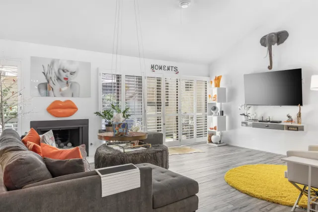 a dining room with wooden floor and a chandelier