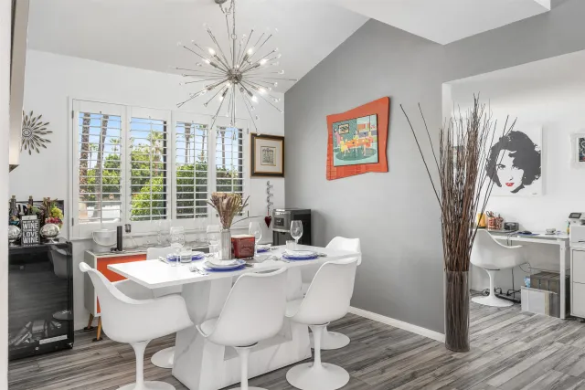 a kitchen with granite countertop a sink a stove and cabinets