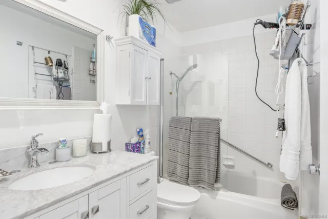 a room with furniture a flat screen tv and a refrigerator