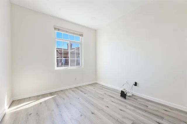 a view of a room with wooden floor and windows
