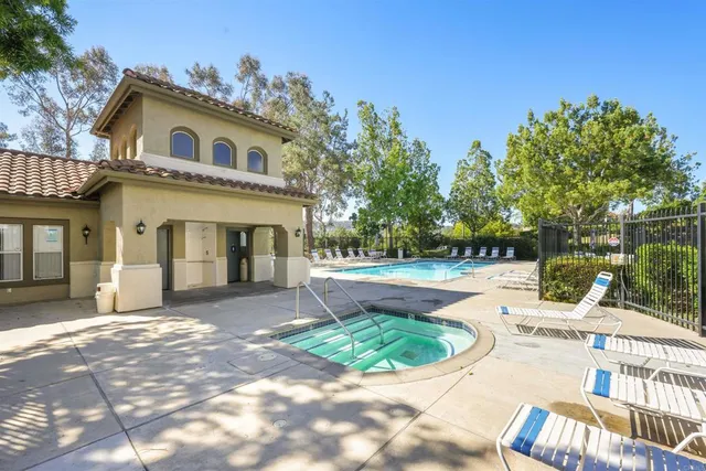 a view of pool with outdoor seating and trees