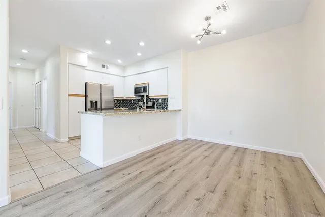 a view of a kitchen with wooden floor and a kitchen