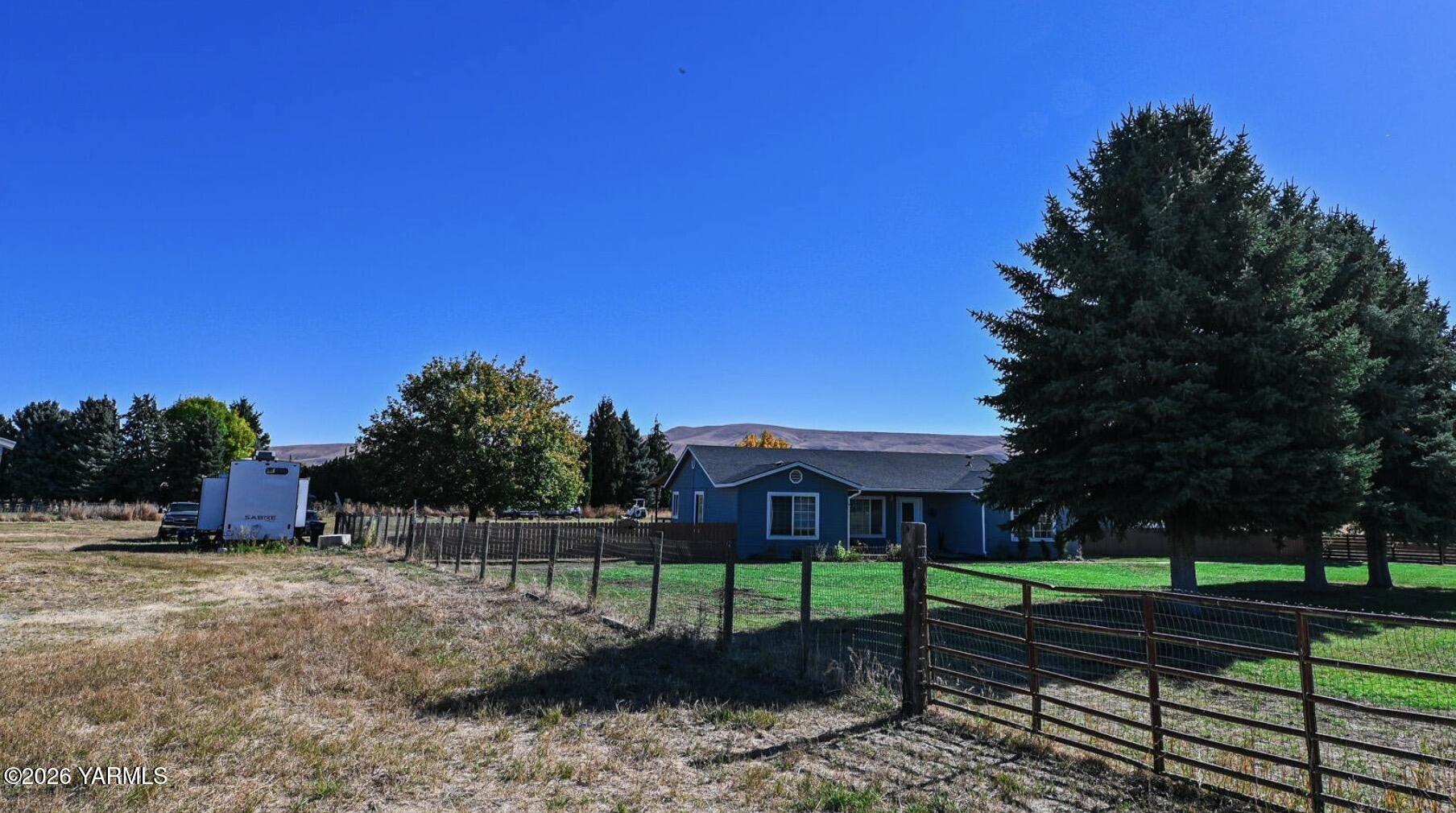 9621 Meadowbrook Road Yakima, WA 98903 - Photo 16 of 26 a view of a house with a backyard