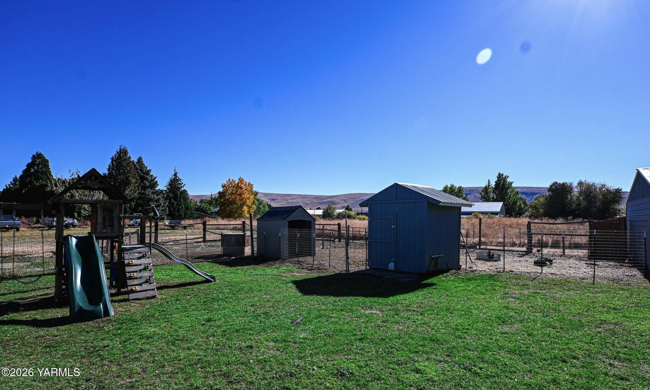 9621 Meadowbrook Road Yakima, WA 98903 - Photo 23 of 26 a view of a house with a backyard porch and sitting area
