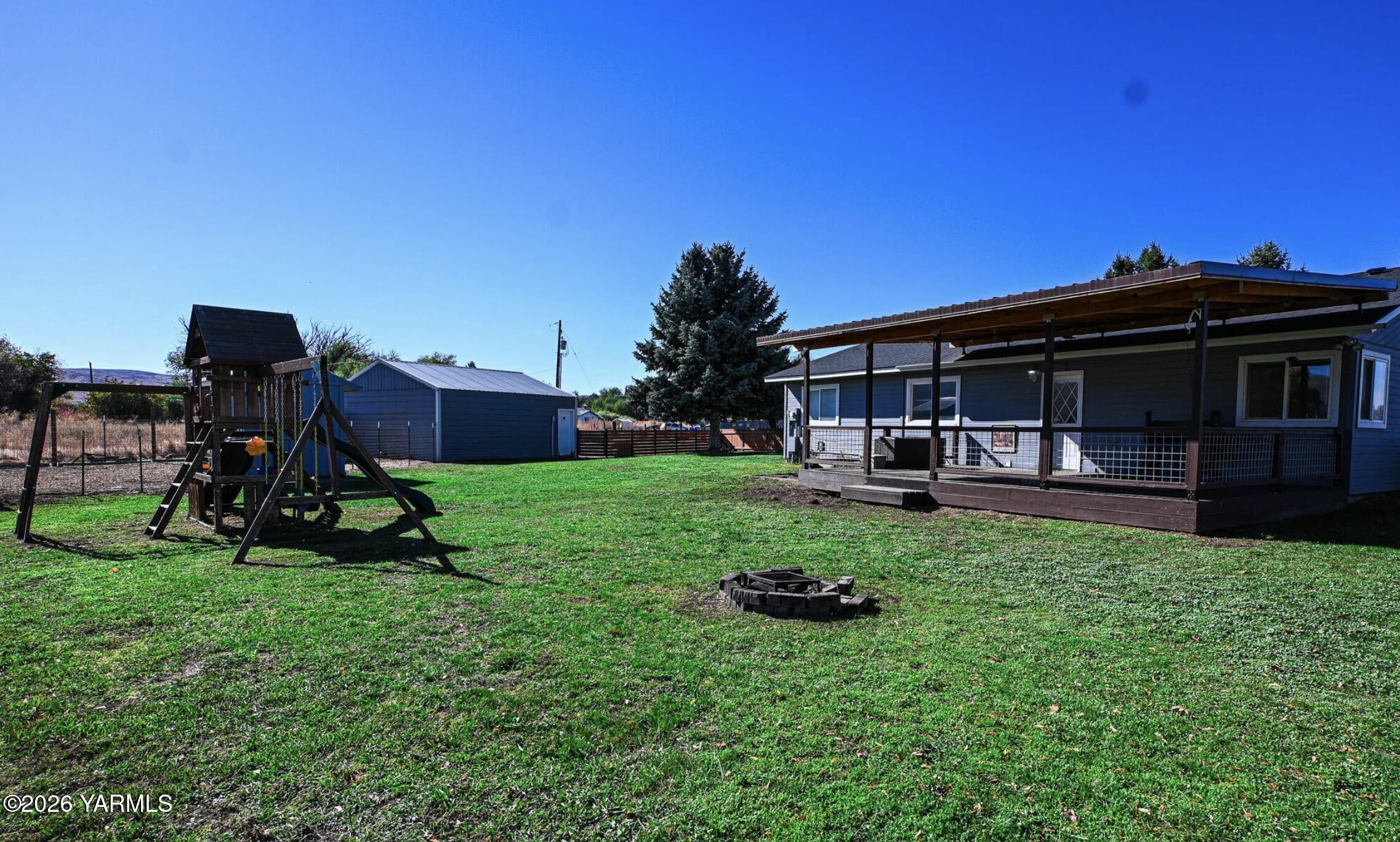 9621 Meadowbrook Road Yakima, WA 98903 - Photo 3 of 26 a view of an house with backyard space and sitting area