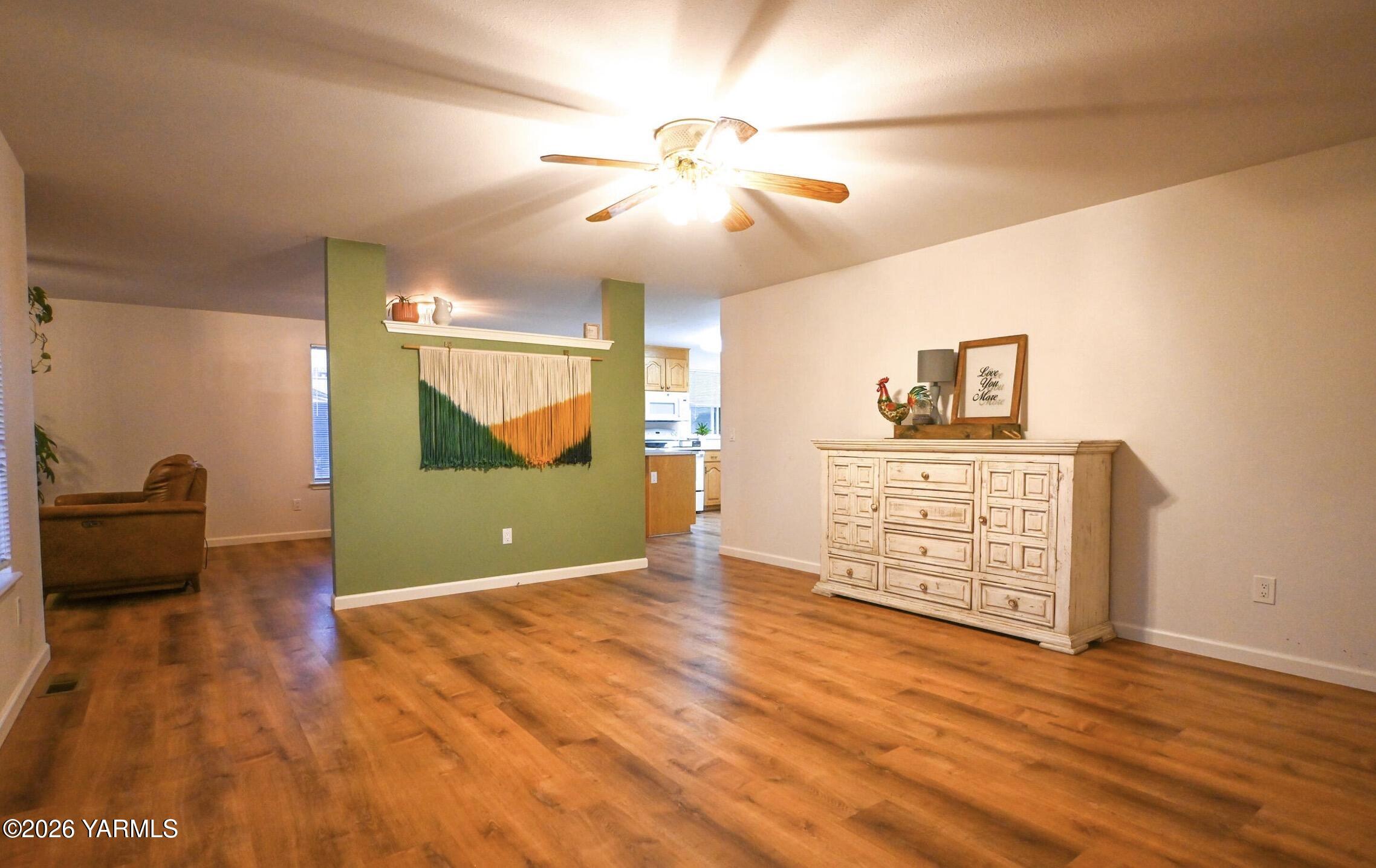 9621 Meadowbrook Road Yakima, WA 98903 - Photo 5 of 26 a view of an empty room with a window and wooden floor