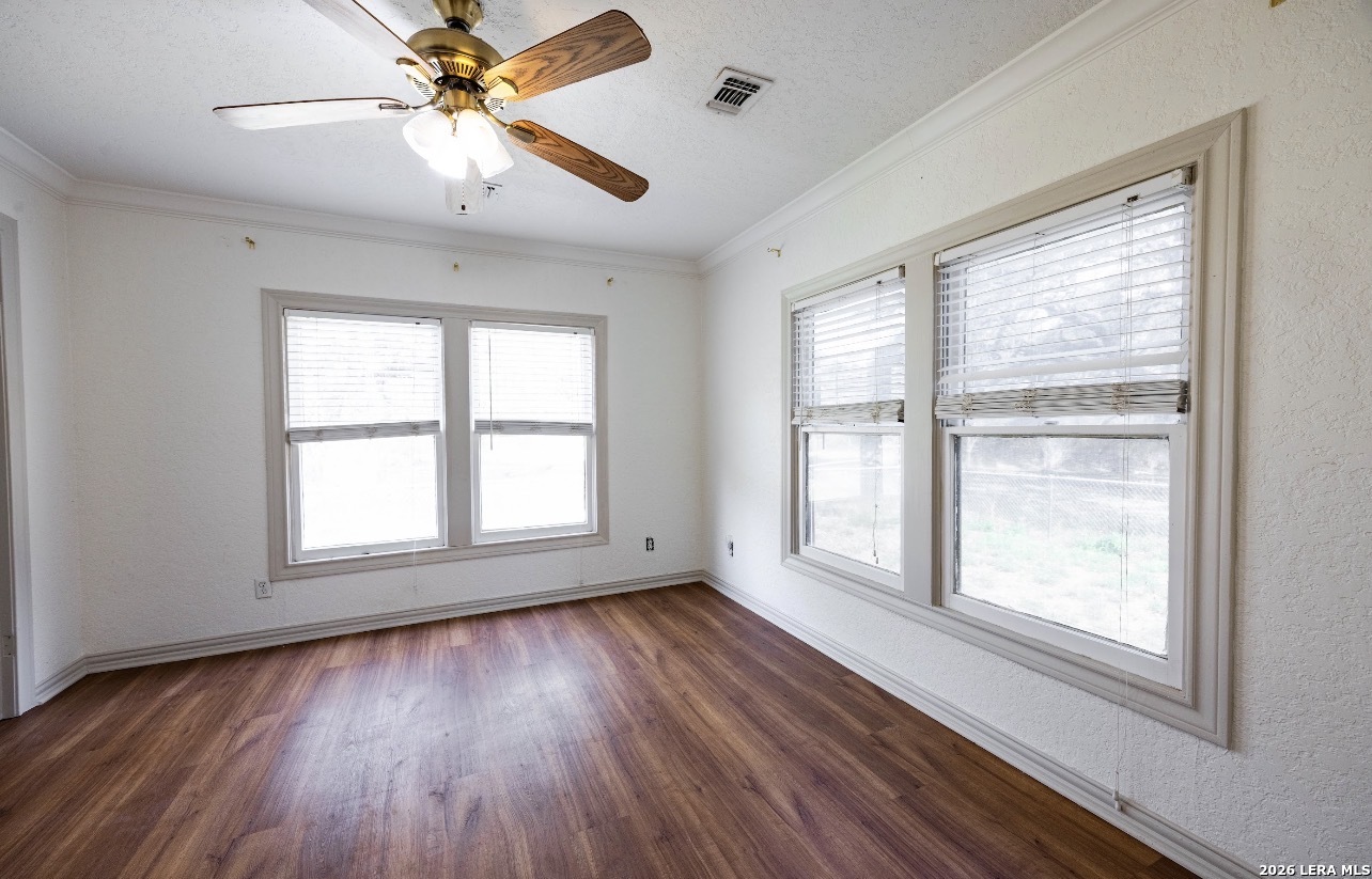 149 South Carroll Street Poth, TX 78147 - Photo 9 of 28 a view of an empty room with wooden floor and a window