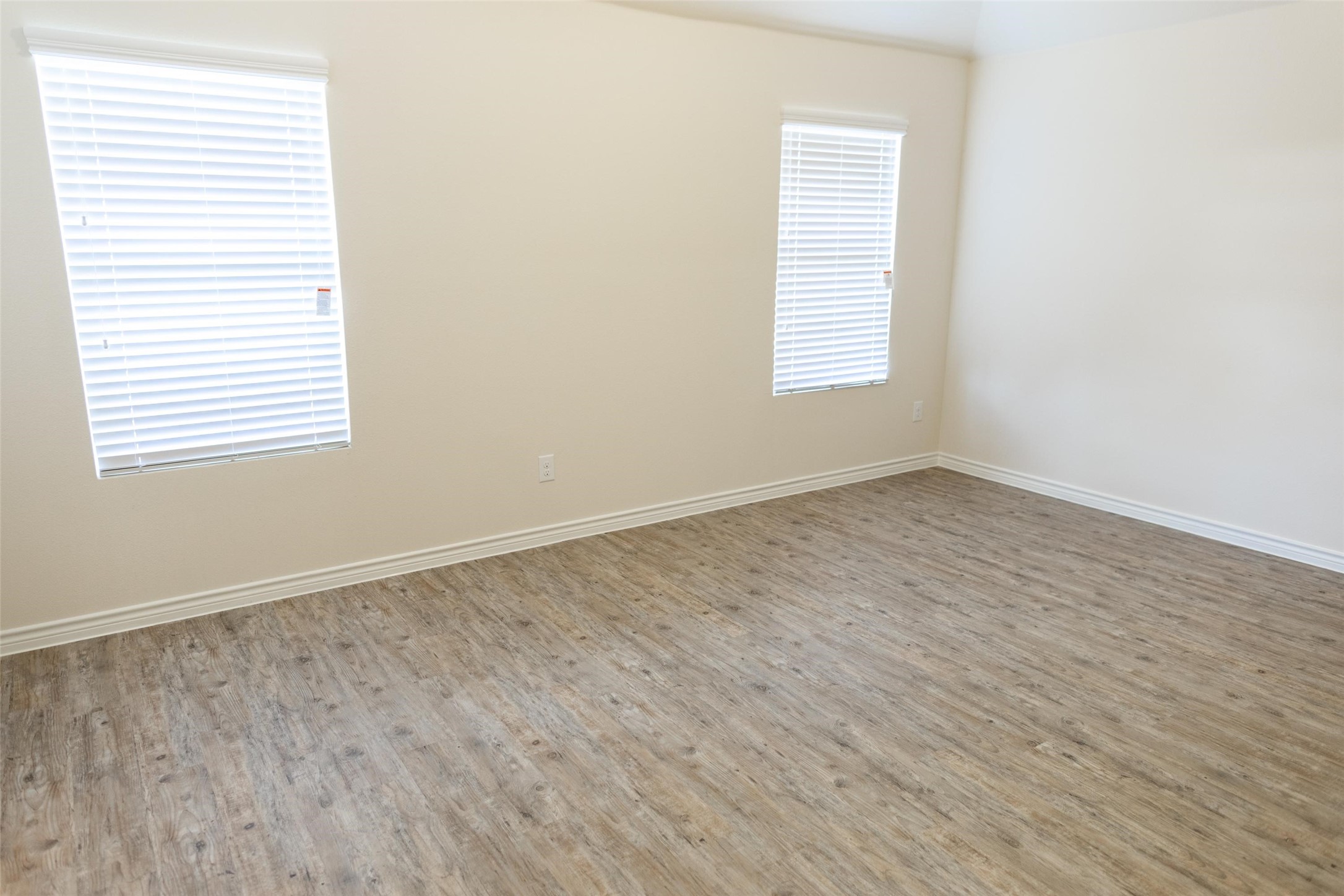 13815 Winding Path Lane Willis, TX 77378 - Photo 9 of 13 an empty room with wooden floor and windows
