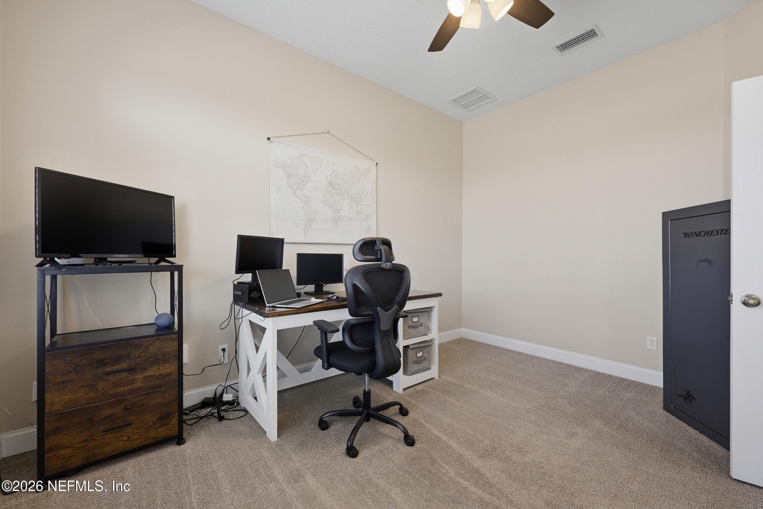 44808 Green Meadows Lane Callahan, FL 32011 - Photo 11 of 41 a view of a workspace with furniture and a flat screen tv