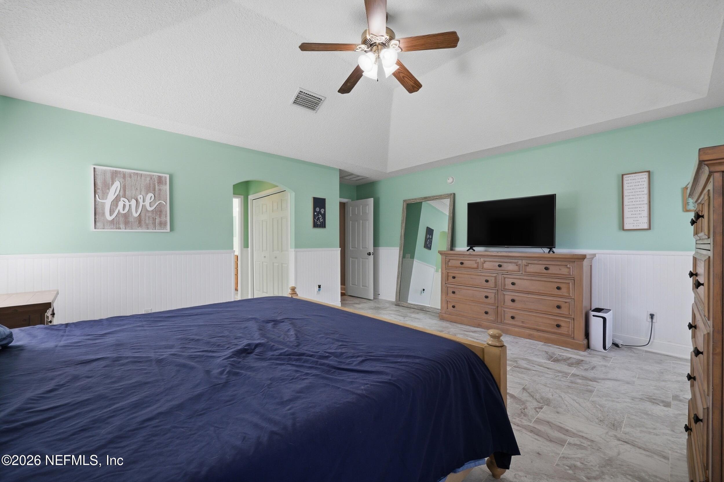 44808 Green Meadows Lane Callahan, FL 32011 - Photo 18 of 41 a bedroom with a bed and a flat screen tv