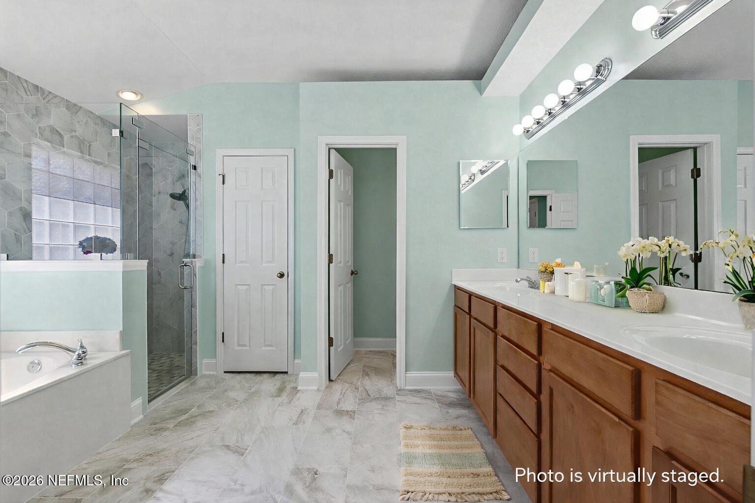44808 Green Meadows Lane Callahan, FL 32011 - Photo 19 of 41 a spacious bathroom with a sink mirror and a bath tub