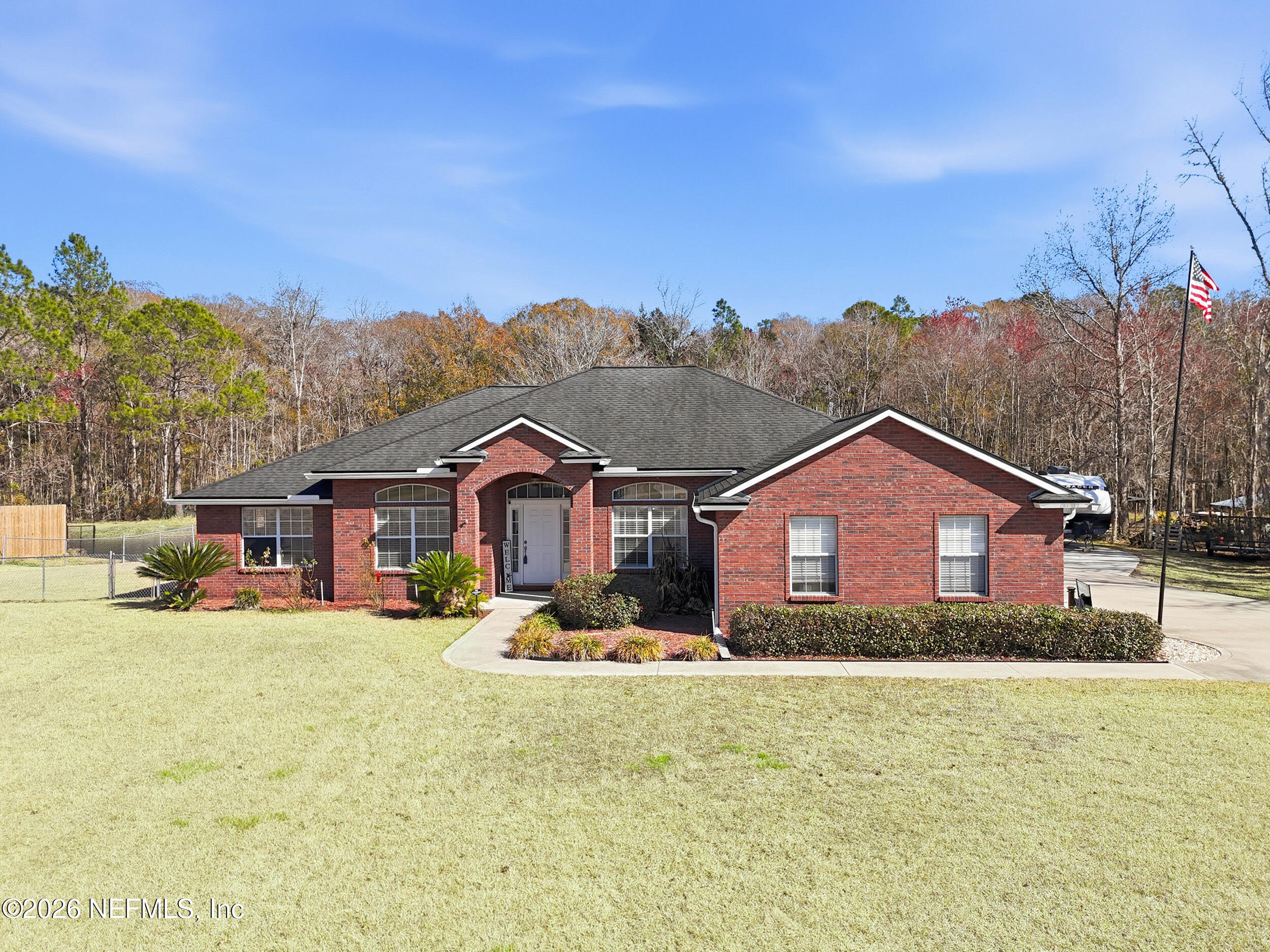 44808 Green Meadows Lane Callahan, FL 32011 - Photo 2 of 41 a view of a big house with a big yard and large trees