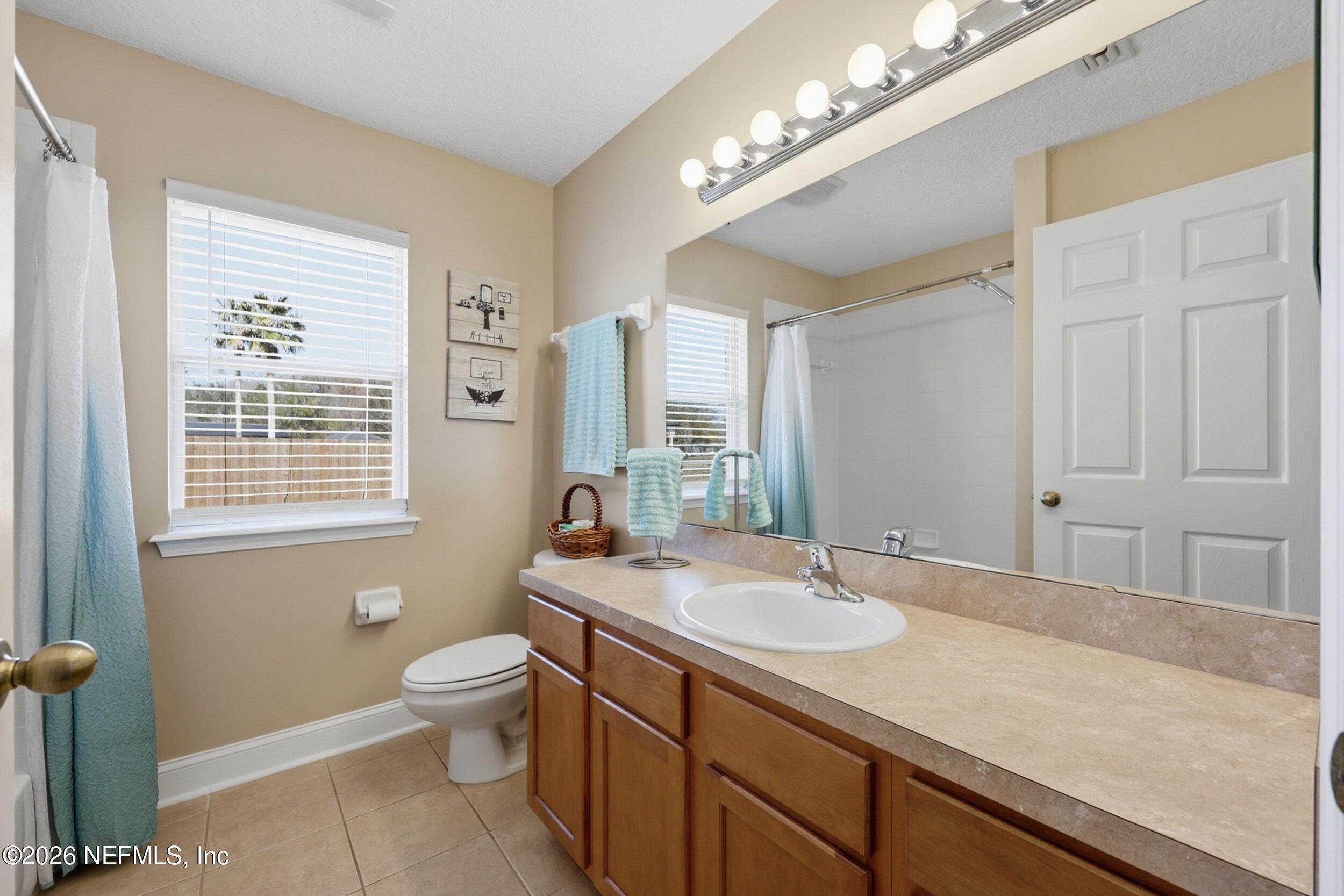 44808 Green Meadows Lane Callahan, FL 32011 - Photo 22 of 41 a bathroom with a sink a large mirror and a toilet