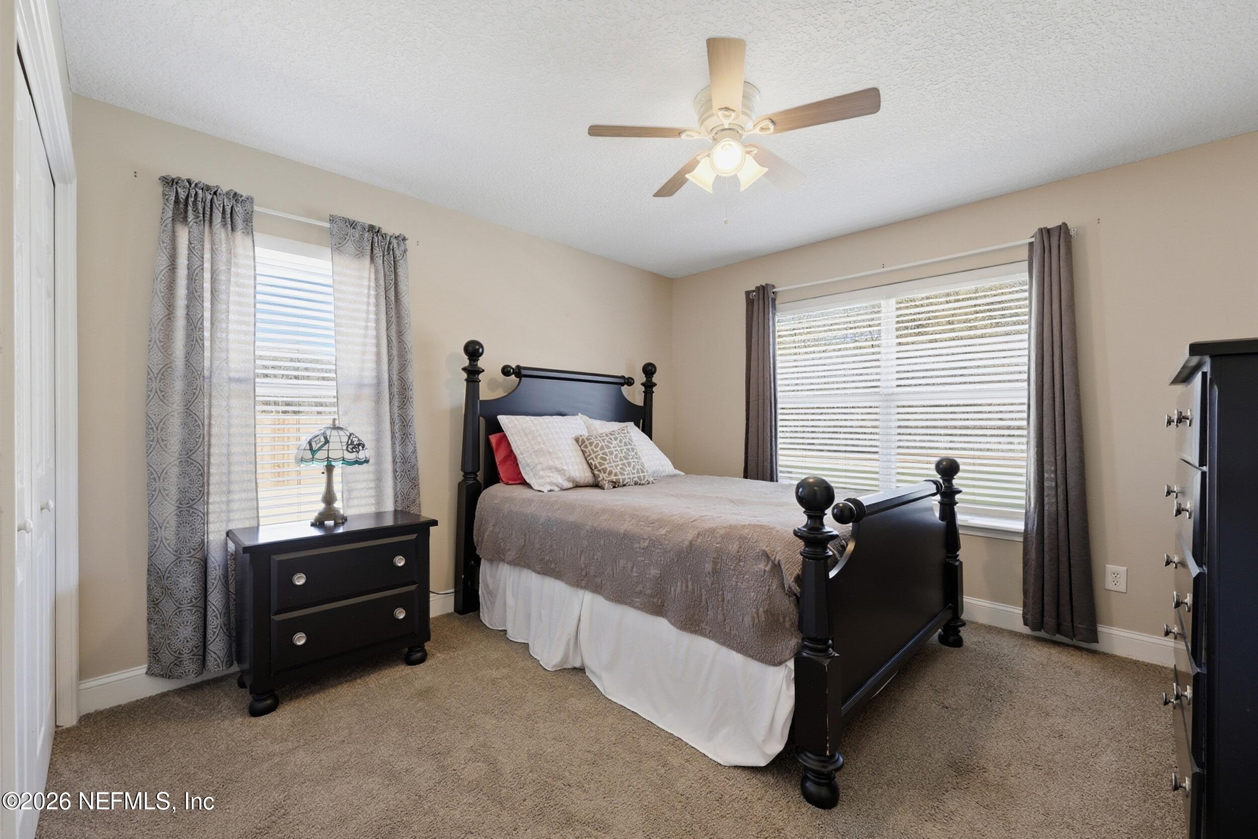 44808 Green Meadows Lane Callahan, FL 32011 - Photo 23 of 41 a bed room with a bed and a ceiling fan