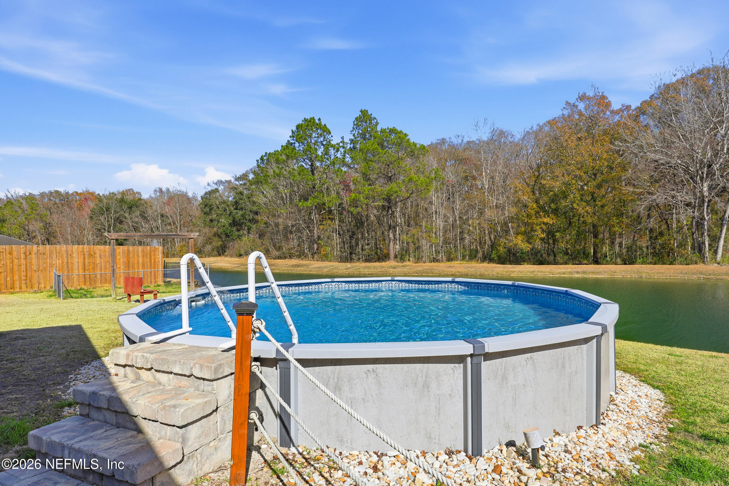 44808 Green Meadows Lane Callahan, FL 32011 - Photo 26 of 41 a view of a swimming pool with a patio