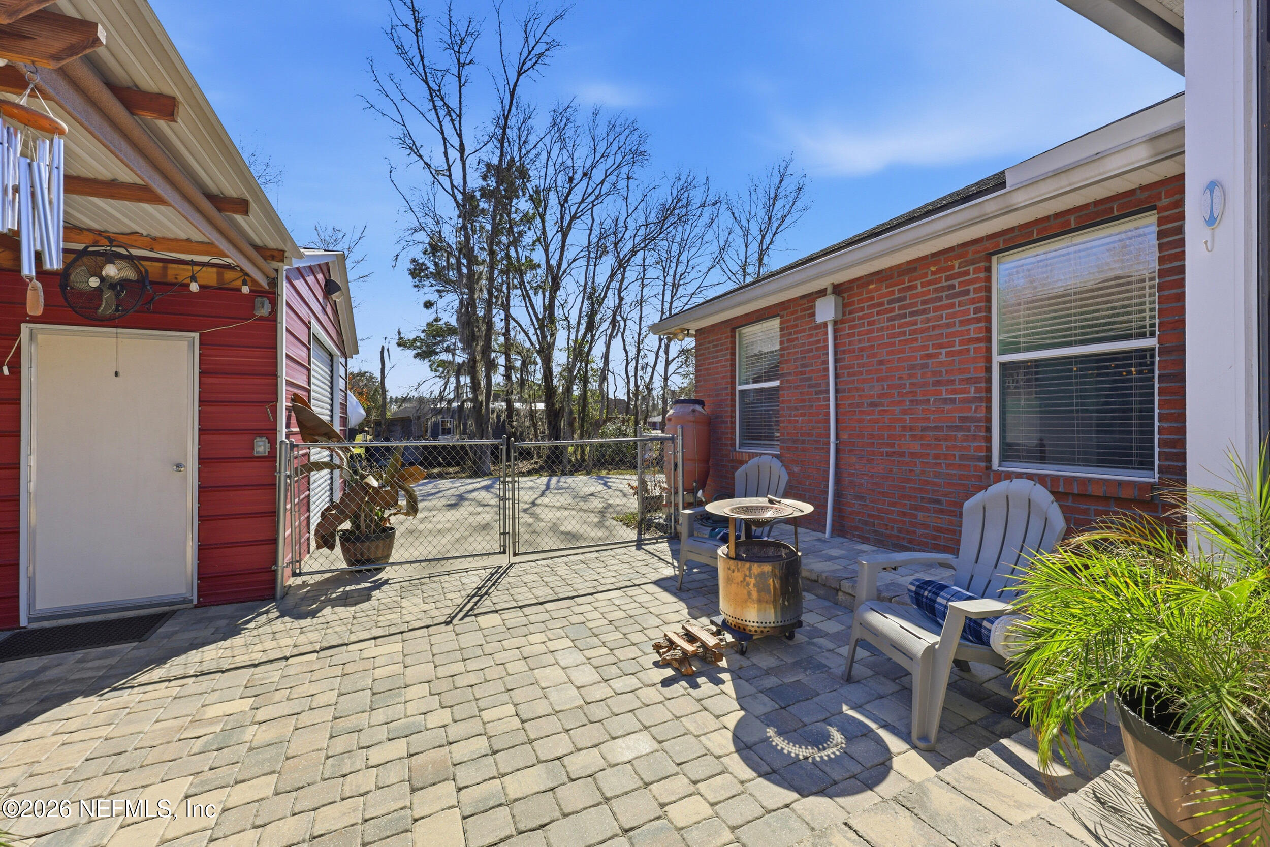 44808 Green Meadows Lane Callahan, FL 32011 - Photo 28 of 41 a view of a patio with table and chairs and potted plants