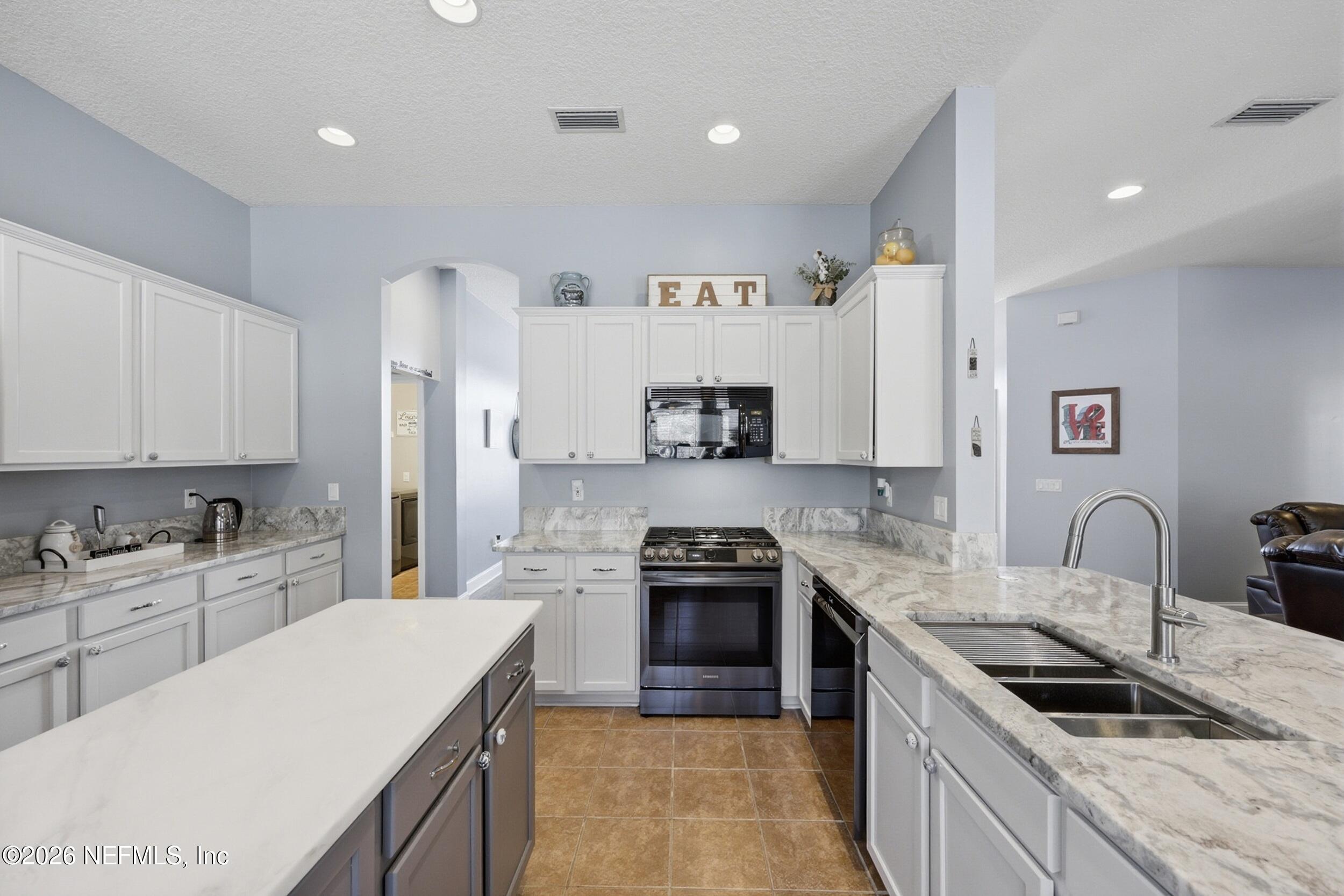 44808 Green Meadows Lane Callahan, FL 32011 - Photo 3 of 41 a kitchen with stainless steel appliances granite countertop a sink stove and refrigerator