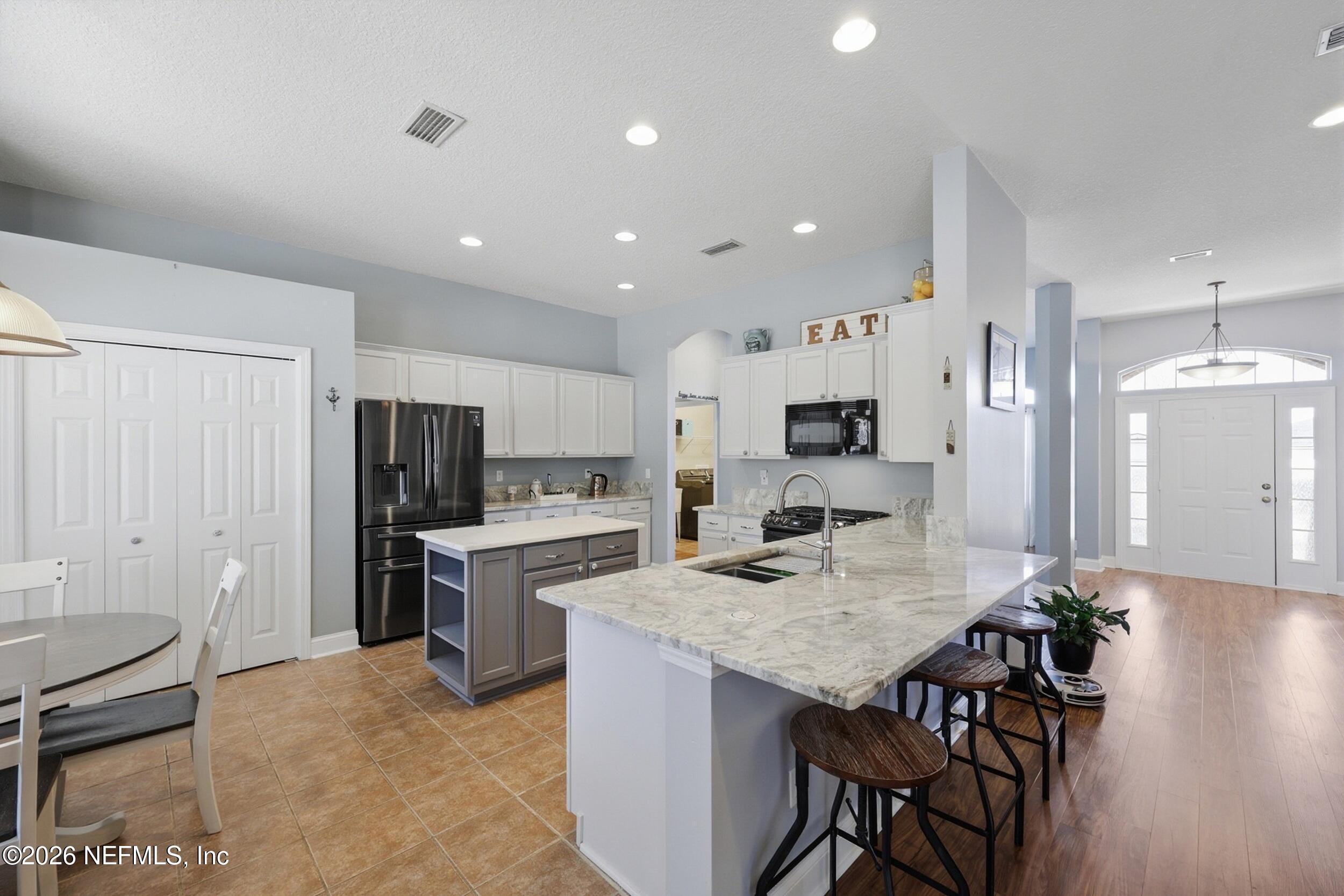 44808 Green Meadows Lane Callahan, FL 32011 - Photo 4 of 41 a kitchen with refrigerator and microwave