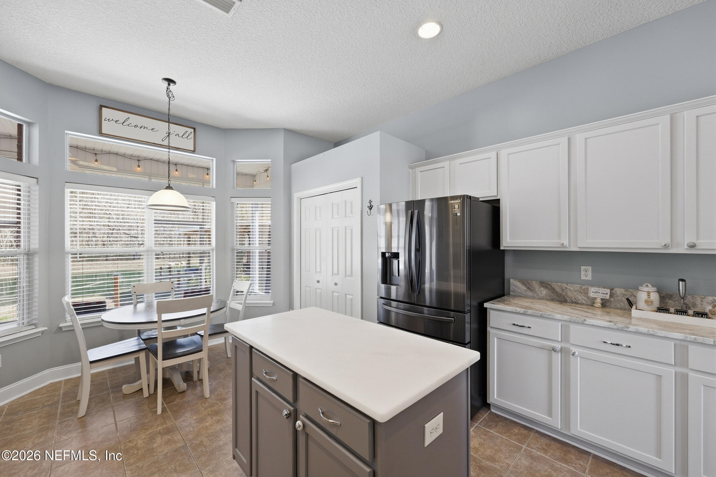 44808 Green Meadows Lane Callahan, FL 32011 - Photo 5 of 41 a kitchen that has a lot of cabinets a sink and a refrigerator in it