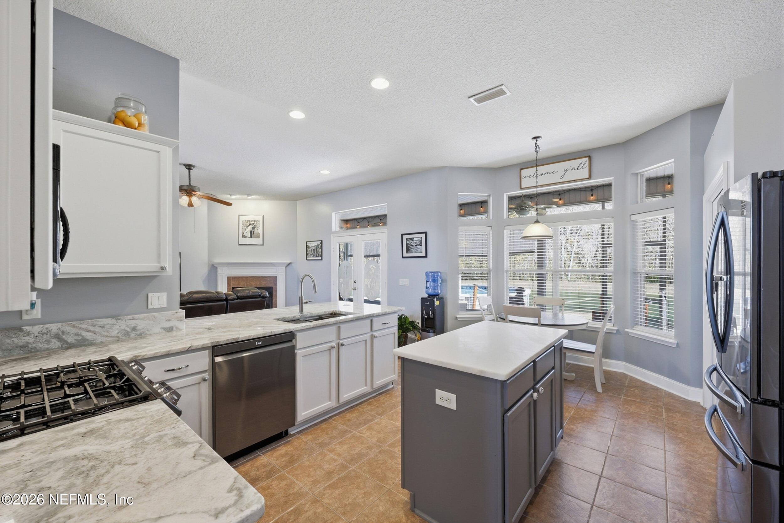 44808 Green Meadows Lane Callahan, FL 32011 - Photo 6 of 41 a large white kitchen with a large window and stainless steel appliances