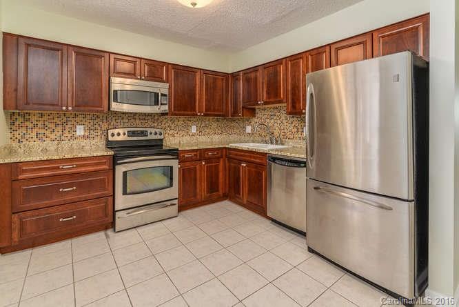 79 Maple Ridge Lane, Unit 79 Asheville, NC 28806 - Photo 6 of 20 a kitchen with granite countertop cabinets and steel stainless steel appliances