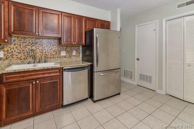 79 Maple Ridge Lane, Unit 79 Asheville, NC 28806 - Photo 7 of 20 a kitchen with stainless steel appliances granite countertop a refrigerator sink and cabinets