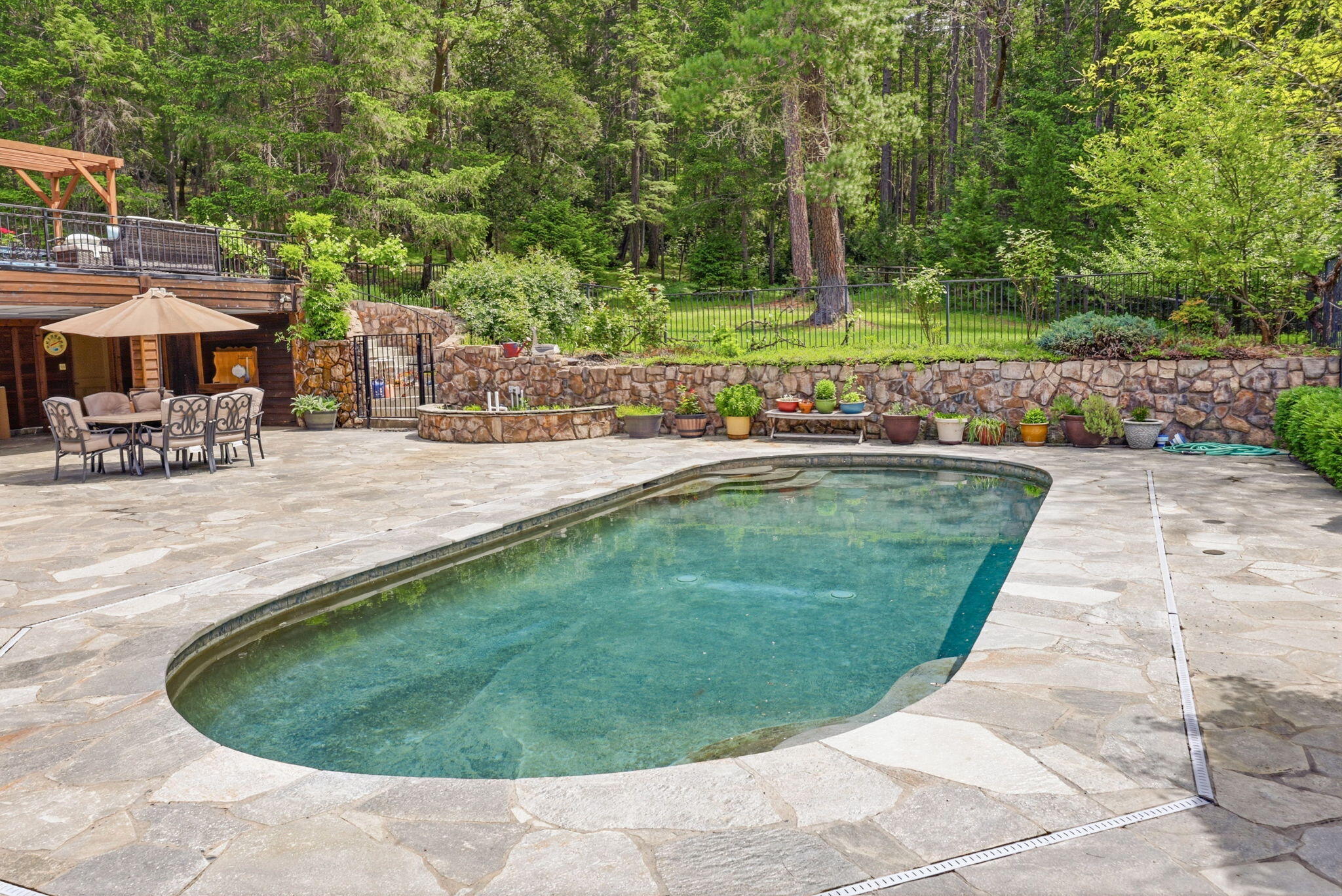 985 Elliott Creek Road Wilderville, OR 97543 - Photo 56 of 98 a view of a swimming pool with a patio