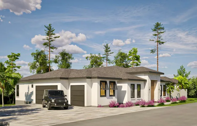 a front view of a house with a yard and a garage