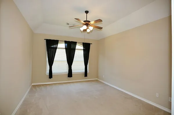an empty room with a empty space and a ceiling fan