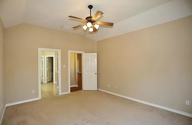 an empty room with a empty space and a ceiling fan