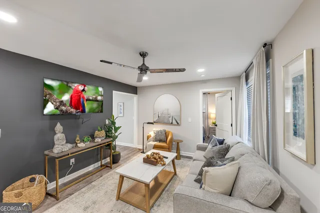 a living room with furniture and a flat screen tv