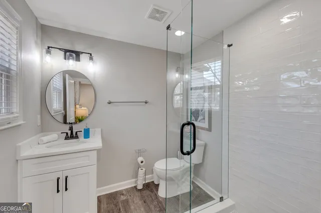 a bathroom with a toilet a sink and a mirror