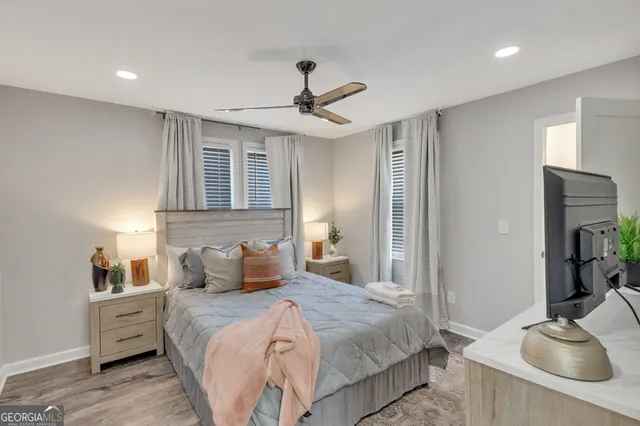 a bedroom with a bed and wooden floor