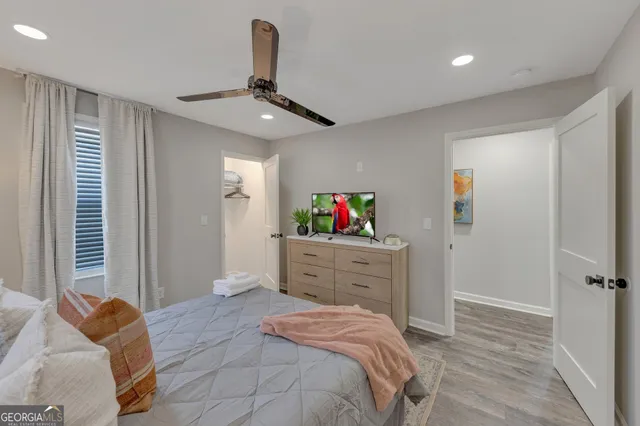 a bedroom with a bed dresser and a window