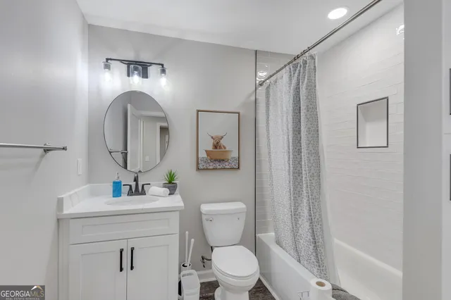 a bathroom with a toilet a sink and a mirror