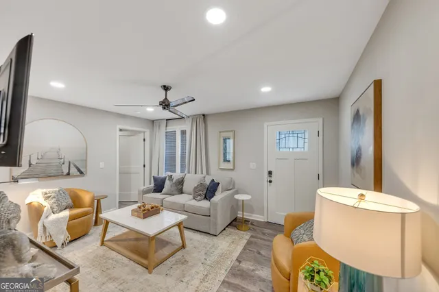 a living room with furniture and a chandelier