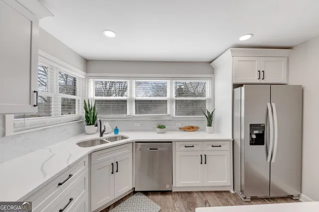 a kitchen with a sink stove and refrigerator