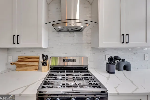 a kitchen with a stove and cabinets