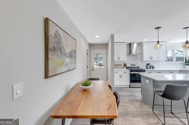 a kitchen with a table chairs stove and cabinets